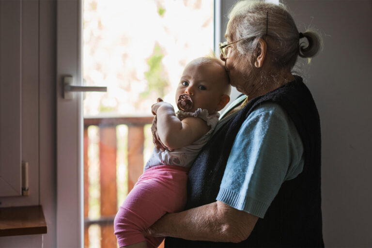 elderly women holding a baby