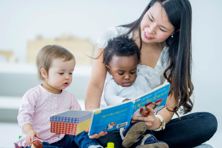 woman reading to two children